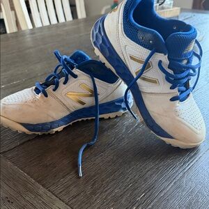 New Balance Kids turf baseball cleats in White, Blue, and Gold